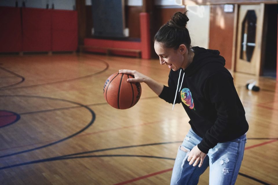 Someone in the Rose Collection hoodie, playing basketball
